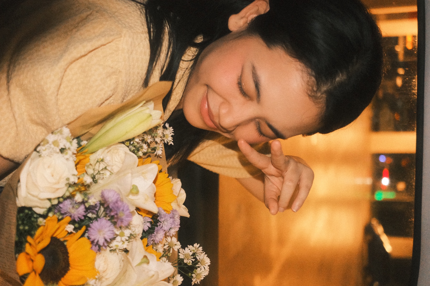 C holding a bouquet of flowers